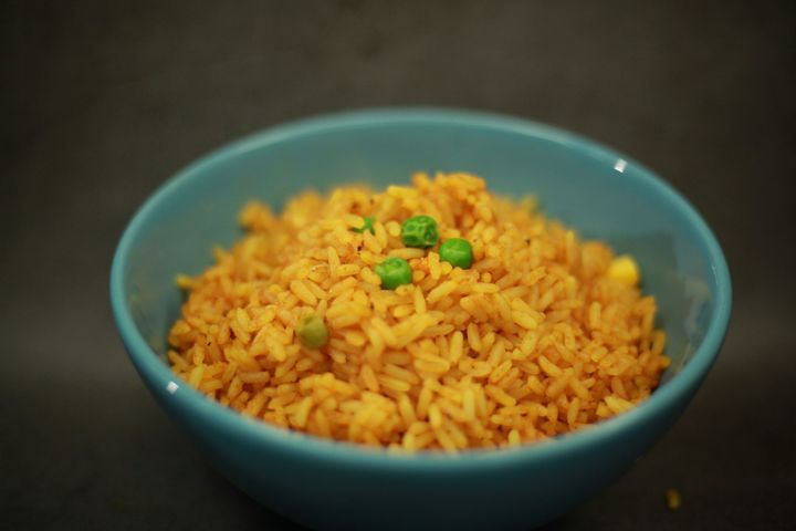 A bowl of rice with green peas